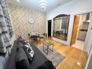 a living room with a couch and a table at 2 Bedroom Apartment In Central London in London