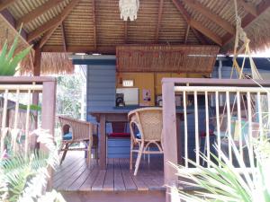 a patio area with a table and chairs at Mango tourist Hostel in Hervey Bay