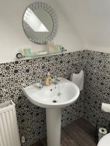 a bathroom with a sink and a mirror at The WestField in Liversedge