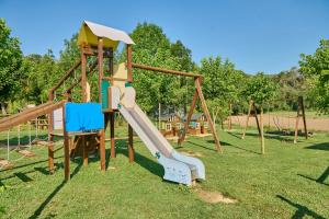 a playground with a slide in a park at Camping-Bungalow la Vall de Campmajor in Sant Miquel de Campmajor