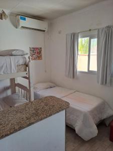a room with two bunk beds and a counter at Departamentos la cascada in Termas de Río Hondo