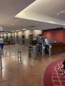 a man working at a desk in a lobby at Alto Buenos Aires in Buenos Aires