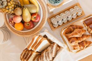 a table topped with various types of bread and pastries at Starlight Hotel in Skala