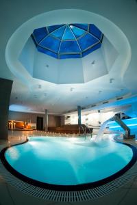 a large pool in a hotel with a ceiling at Hotel Štekl in Hluboká nad Vltavou