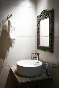 a bathroom with a white sink and a mirror at San José del Pacífico- Cabañas Camino al Cielo 3 in San Jose del Pacifico