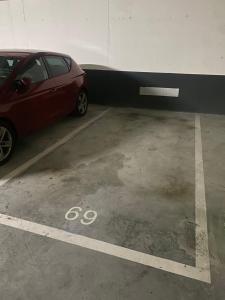 a red car parked in a parking lot at Apartamento en San Mames in Bilbao