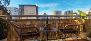 a patio with two chairs and a table on a balcony at Boquerón 5 in Torre del Mar