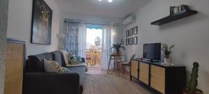 a living room with a couch and a television at Boquerón 5 in Torre del Mar
