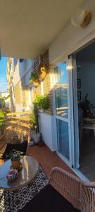 a patio with a table and chairs on a balcony at Boquerón 5 in Torre del Mar