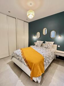 a bedroom with a bed with a yellow blanket on it at L'école des frères in Saint-Julien-Chapteuil +9 photos