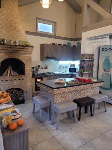 a large kitchen with a counter and a fireplace at Vila Flory Voronet in Voronet