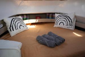 a room with two beds and two pillows in a room at Night at sea Puerto Calero in Puerto Calero