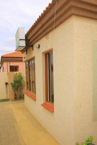 a building with windows on the side of it at Kunzi B&B in Gaborone