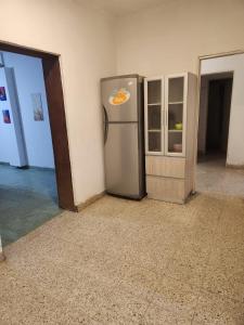 a refrigerator in the corner of a room at Casa Verde in Centenario