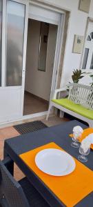 a table with a white plate on top of it at Bienvenue chez Rosa in Vila Real de Santo António