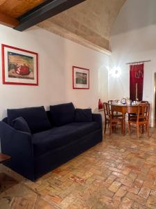 a living room with a couch and a table at Hotel San Giorgio in Matera