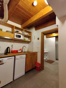 a kitchen with a sink and a microwave at Apartmani Nono in Jahorina