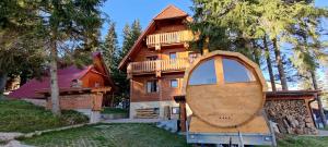 a wooden house with a boat in front of it at Apartmani Nono in Jahorina