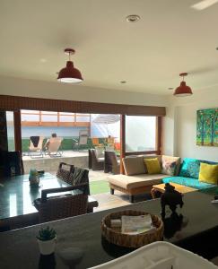 salon z kanapą i stołem w obiekcie El Templo Surf House w mieście Punta Hermosa