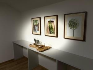 a white table with three pictures on a wall at Pension Stöllinger mit Traumausblick in Fuschl am See