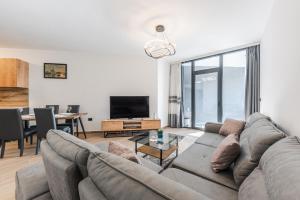 a living room with a couch and a table at Hill Side Suite by PS in Durrës