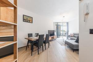 a dining room and living room with a table and chairs at Hill Side Suite by PS in Durrës