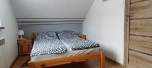 a bed in a small room with at Domek Pod Górą Żar in Międzybrodzie Żywieckie