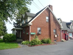 a brick building with a office sign on it at Red Rose Motel in Elizabethtown