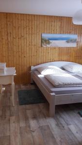 a bedroom with a bed and a desk and a table at Ferienwohnung Alona in Garz