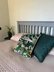 a pillow sitting on top of a bed at White Oaks Sussex in Twineham