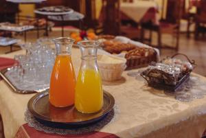 two bottles of orange juice sitting on a table at Hotel Grande in Celje