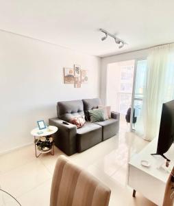 a living room with a couch and a table at Apartamento Charme Benfica in Fortaleza