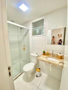 a bathroom with a toilet and a sink and a shower at Apartamento Charme Benfica in Fortaleza