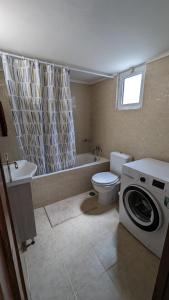 a bathroom with a toilet and a washing machine at GIANNIS HOUSE in Rhodes Town +21 photos