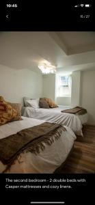 a bedroom with two beds and a window at 2 Bedroom by Zoo, Metro, Park and Embassies in Forest Hills - Best Location in Washington