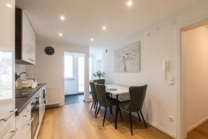 a kitchen and dining room with a table and chairs at Authi's Charmante Stube in Kirchheim unter Teck