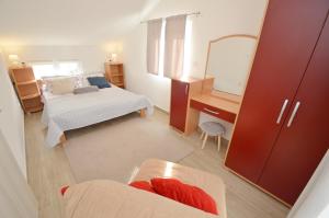 a bedroom with a bed and a desk with a mirror at La Mar Mar in Kotor