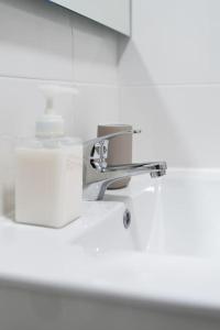 a bathroom sink with a chrome water faucet at Cozy Bohemian Duplex-Lemon in Lisbon