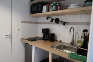 a kitchen with a sink and a counter top at Appartement avec vue sur le lez in Montpellier