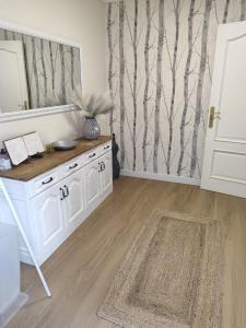 a room with a white cabinet and a mirror at Casa Pepa in Corcubión