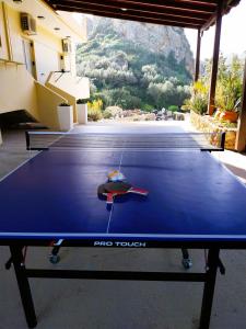 a ping pong table with a ping paddle on it at kallia's lux apt with sea view & cool jacuzzi in Plataniás