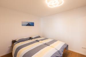 a bedroom with a bed in a white room at Authi's Charmante Stube in Kirchheim unter Teck