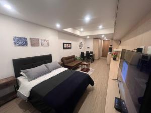a bedroom with a bed and a flat screen tv at Solar 1117 in Chía