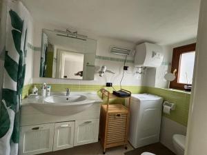 a bathroom with a sink and a mirror at Casa vacanze A&P in Azzano