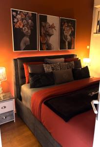 a bedroom with a bed with pictures on the wall at Bienvenue chez Maxime in Saint-Denis