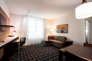 a living room with a couch and a table at TownePlace Suites by Marriott San Mateo Foster City in Foster City