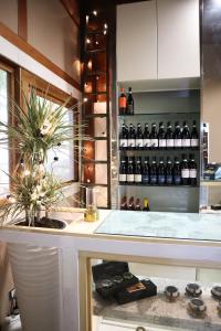 a kitchen with a counter with bottles of wine at Villa Alba Boutique Hotel in Pescara
