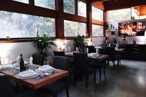 a dining room with tables and chairs and windows at Villa Alba Boutique Hotel in Pescara