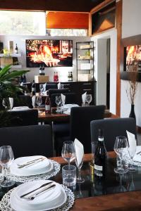 a dining room with a table with plates and wine glasses at Villa Alba Boutique Hotel in Pescara