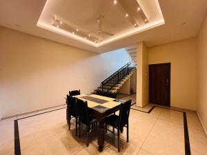 a dining room with a table and chairs and a staircase at EDENS SNOW CASTLE in Anachal